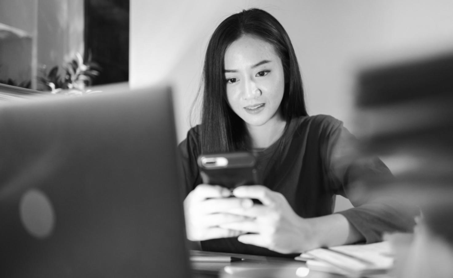 Business owner reviewing financial reports and making planning notes